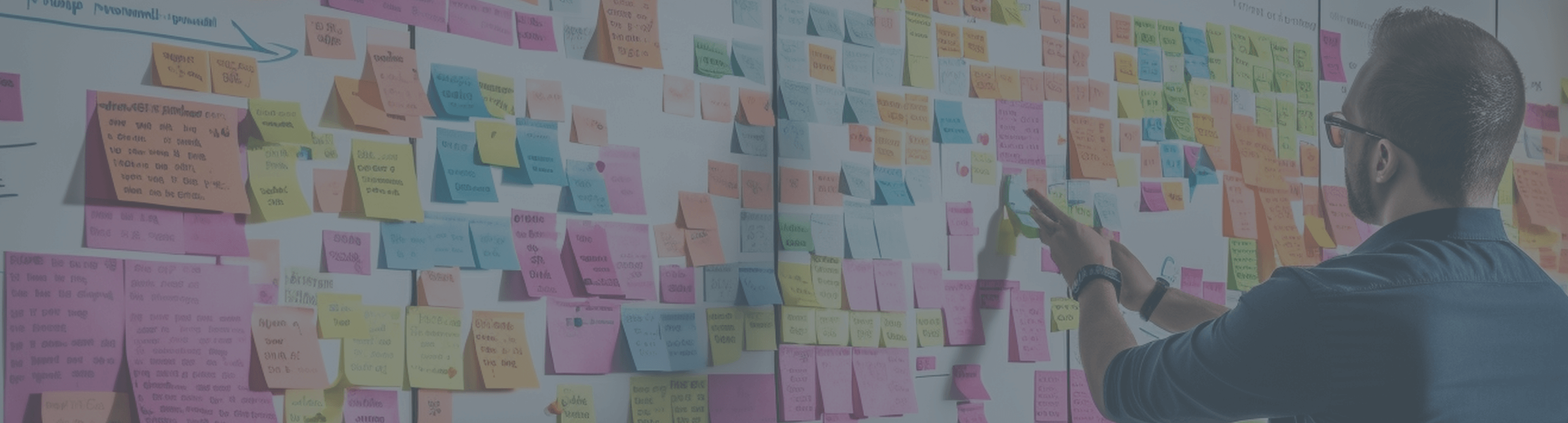 Person organizing colorful sticky notes on a board, illustrating digital experience consulting for insurance and healthcare sectors
